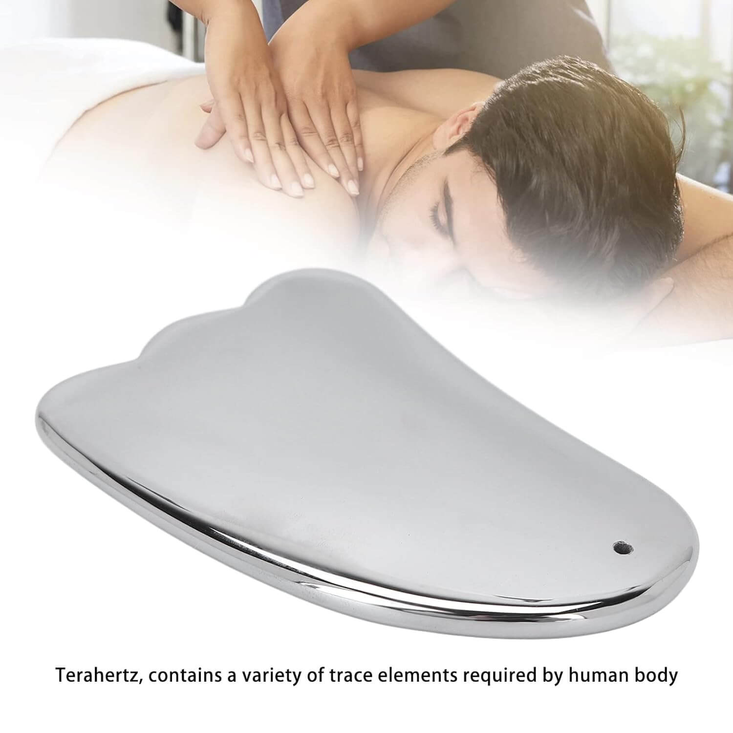The The Terahertz Gua Sha tool. A man getting a back massage in the background.